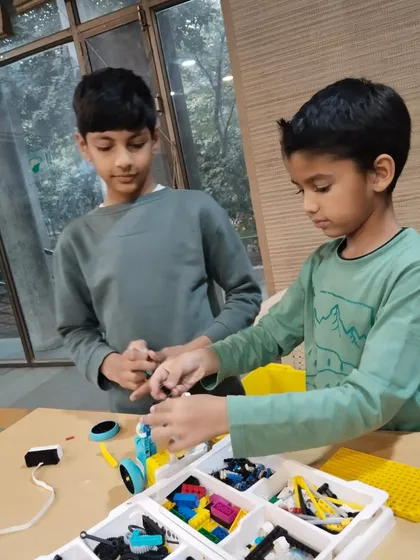 Collaboration is key in my classes. Here, two students work together on a LEGO Spike robot, sharing ideas and troubleshooting their design as a team.