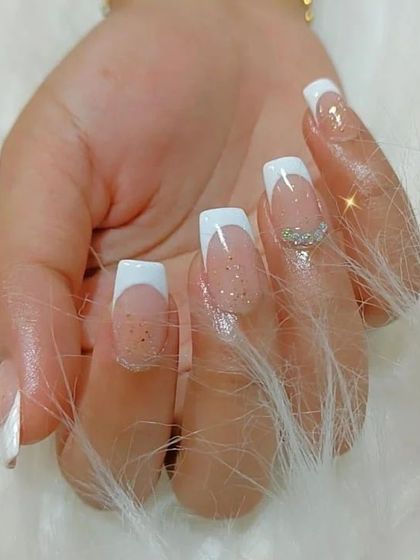 Another angle of the glittery French manicure, showing the fine shimmer in the base polish.