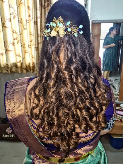 Voluminous curls for a party look. I used different techniques to create texture and bounce, and the style is completed with a stylish gold and blue hair accessory.