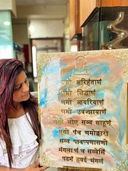 Holding a finished Navkar Mantra frame made by a student. Each piece that comes out of my workshop has its own story and energy, and this one is simply beautiful.