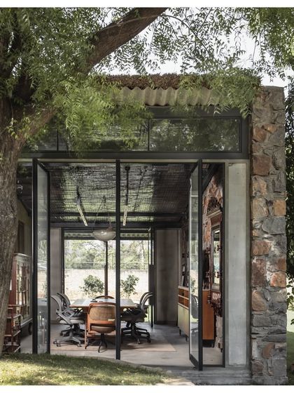 Our own studio is a prime example of our biophilic design philosophy. The workspace is housed in a structure that opens up to the surrounding landscape, with large glass doors that blur the boundary between inside and out.