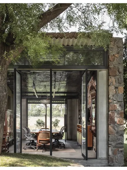 Our own studio is a prime example of our biophilic design philosophy. The workspace is housed in a structure that opens up to the surrounding landscape, with large glass doors that blur the boundary between inside and out.