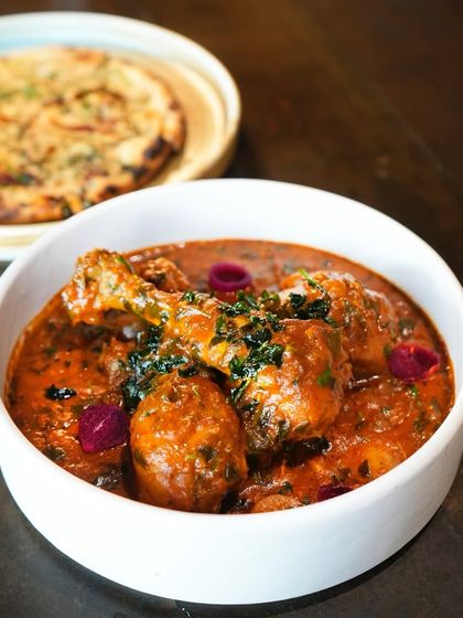 Methi Murgh with khatta pyaaz, a seasonal specialty. The slight bitterness of fenugreek is beautifully balanced with the rich chicken curry, making it a winter favorite for our guests.