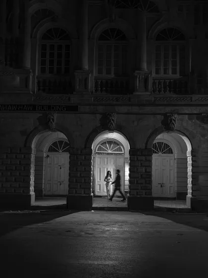 A cinematic moment captured in the quiet city streets. This black and white pre-wedding photograph shows how we can turn any location into a timeless, romantic backdrop for your love story.
