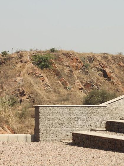 The amphitheatre set against the backdrop of the Aravali hills. The project is an example of landscape architecture that creates a functional community space while respecting and preserving the local ecology.