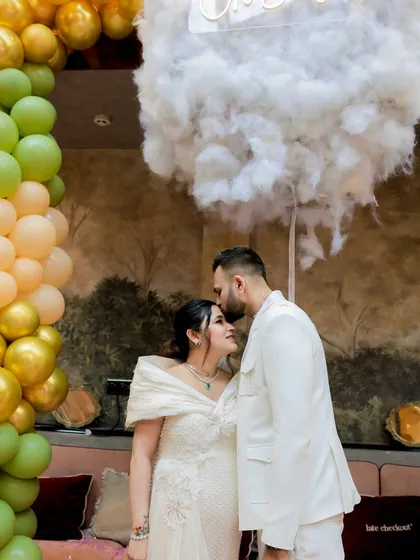 A repeat of a beautiful, tender moment. This shot captures the love and anticipation perfectly, framed by the cloud and balloon decor.