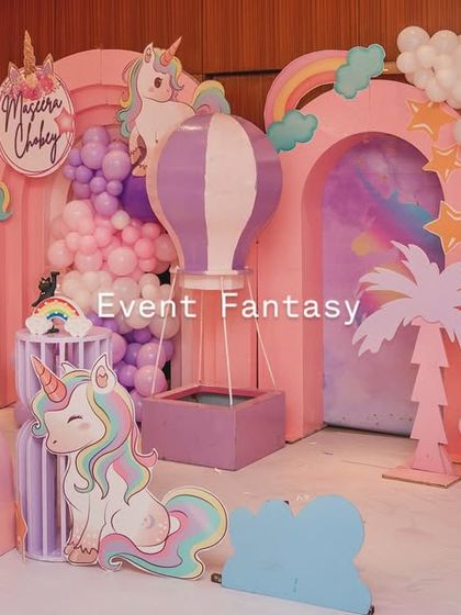 A full view of the unicorn fantasy land, with a large marquee number '5' and a fluffy balloon sheep adding to the whimsical charm.