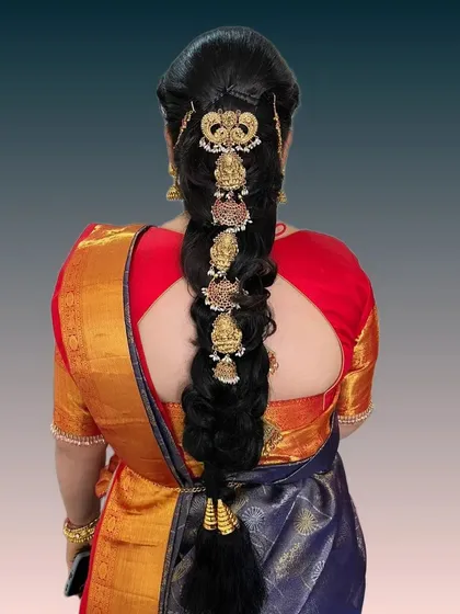A modern fusion braid that incorporates traditional temple jewelry motifs in a contemporary layout. This is perfect for brides who want a unique twist on a classic style.