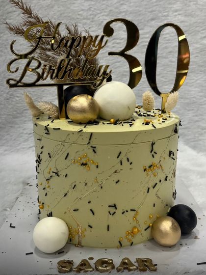Another angle of our stylish 30th birthday cake, showing the custom name and number toppers. We can personalize any cake to make your milestone celebration feel truly special.
