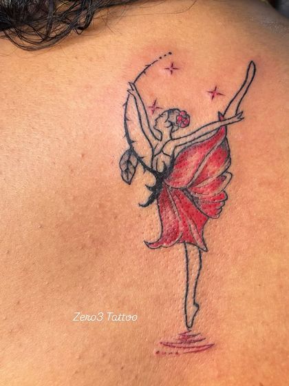 A close-up of the dancer tattoo, highlighting the delicate linework and sparkling star details.