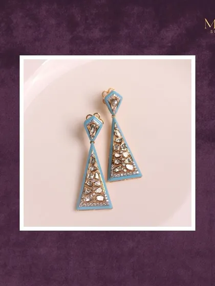 These geometric earrings feature Polki diamonds set in a modern triangular design with a beautiful sky-blue enamel. A perfect example of how we blend traditional crafts with contemporary style.