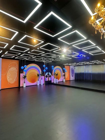 A full view of our main floor, showcasing the large mirrored wall which is perfect for dance rehearsals, alongside our various movable set panels. The combination of the black floor and LED ceiling offers a high-contrast, professional look for any production.