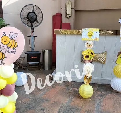 Even the smaller details of the party can match the theme. Here are some decorative elements from the bee-themed baby shower, including cute signs and themed paper lanterns.