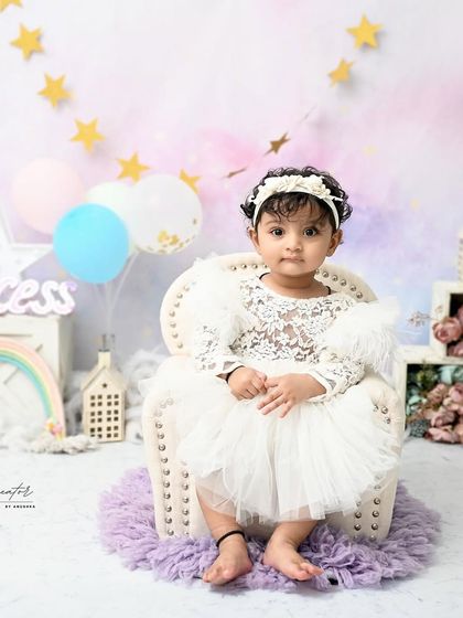 A little princess in her pastel kingdom. This dreamy setup with a rainbow, stars, and soft colors is perfect for a whimsical and magical first birthday.