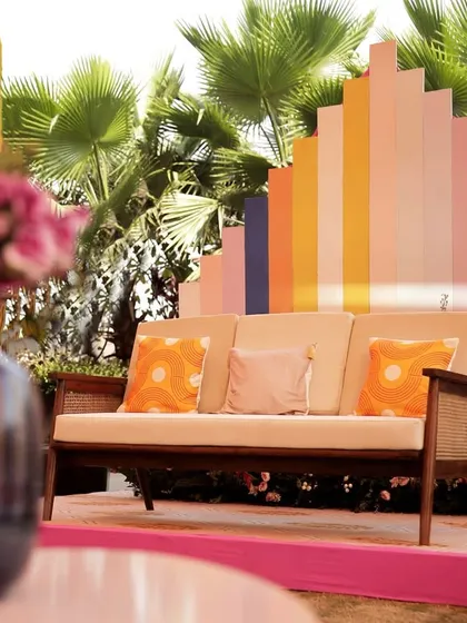 A comfortable and stylish lounge area with a colorful, abstract backdrop, allowing guests to relax and soak in the vibrant atmosphere.