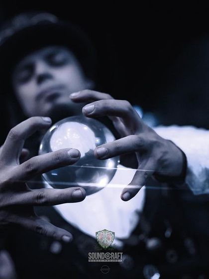 A close-up on the artist's hands as he manipulates the crystal ball, making it appear to float weightlessly. This showcases the incredible skill behind the illusion.
