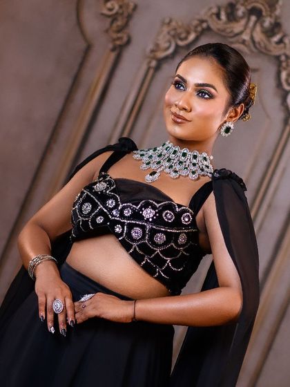 A glamorous reception look taught at a masterclass. The model is posed against our elegant carved wall, showing how the same backdrop can work for both traditional and modern styles.