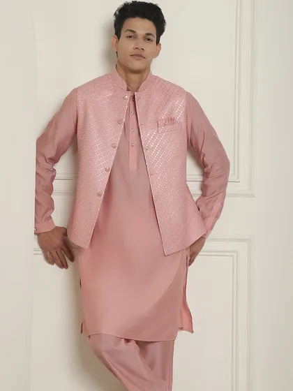 This pink Kurta Pajama Jacket set is a great option for a day event. The textured jacket adds a modern touch to the classic silhouette, ensuring 'style bhi, comfort bhi'.