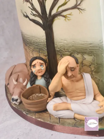 A close-up of the 'Adharma' side of the Dharmasthapane cake, showing the weeping farmer and child amidst a barren landscape. Sculpting such complex and sorrowful expressions in fondant was a challenge I was excited to take on.