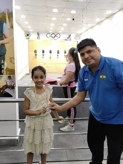I always enjoy presenting medals to our promising young shooters. Here, one of our students receives her medal in front of our professional 10m range.