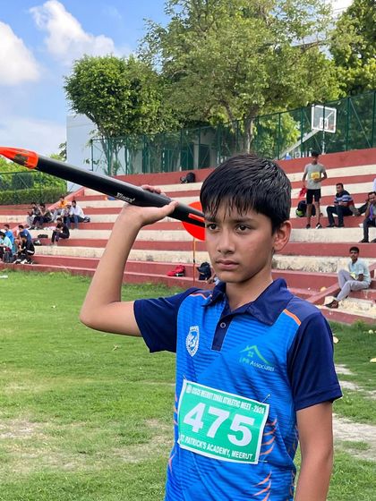 A young javelin thrower focuses before his attempt at a competition. We teach mental preparation as well as physical skill.