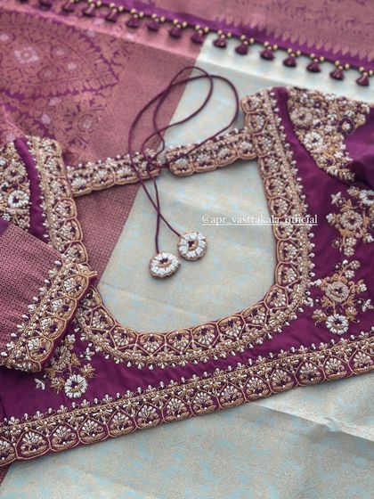 The back of the purple blouse, with a U-shape neckline and tassels.