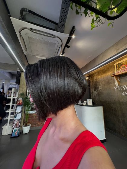 A different angle of our classic bob haircut. The precision of the cut creates a sleek and polished look that is effortlessly chic.