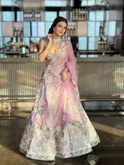 The full silhouette of this pastel floral lehenga against a modern backdrop. It’s a look that feels both fresh and timeless.