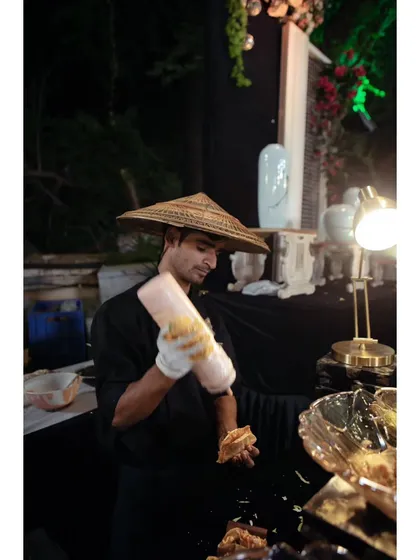 A member of my team dressed in theme-appropriate attire for a Pan-Asian station, showcasing how we adapt our presentation to fit the event's concept.