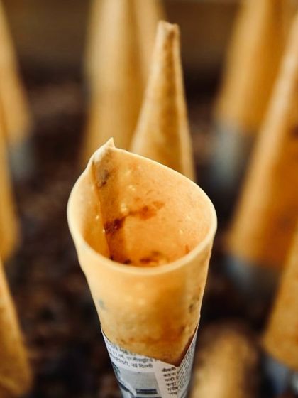 A close-up of our cornett, showing the delicate, crisp shell filled with a savoury mixture. It's a perfect one-bite wonder that encapsulates our inventive approach.