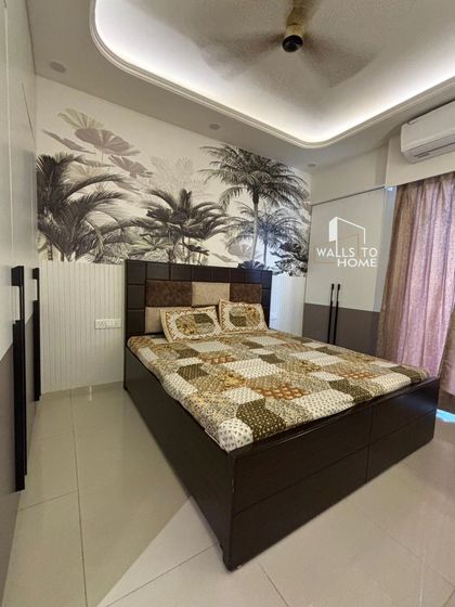 I used a bold, tropical-themed wallpaper to create a stunning accent wall in this bedroom. The monochrome palm design adds a touch of nature and drama, perfectly complementing the dark wood bed and checkered headboard.