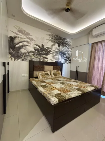 This bedroom features a striking tropical-themed wallpaper behind the bed, creating a resort-like feel. The dark wood bed and two-tone wardrobe complete the modern, aesthetic look.