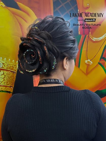 A real-life application of the rose bun with added glitter, demonstrating how to adapt a classic style for a more glamorous look.