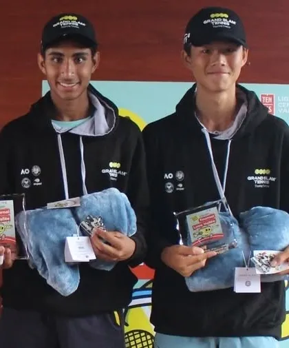 Tavish Pahwa and his partner receiving their awards after becoming Doubles Champions on the U16 European Junior Tour in France. This experience is invaluable for their growth.