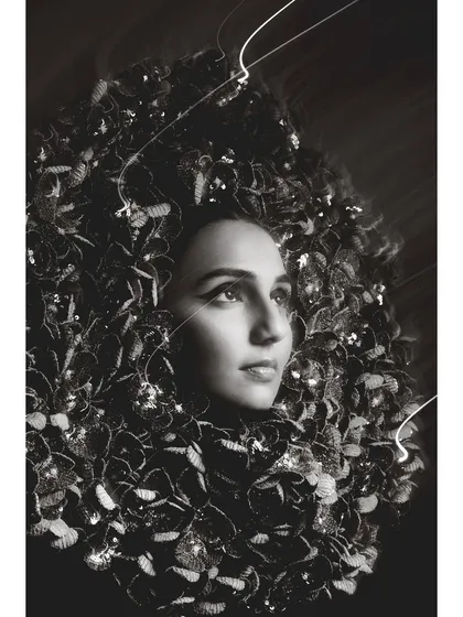 An artistic outtake from the Elle cover shoot with Masoom Minawala. This close-up, black and white portrait emphasizes the intricate details of the headpiece and the model's expressive gaze, creating a more intimate and abstract fashion photograph.