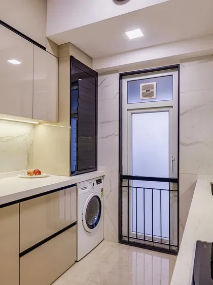 The utility area of the parallel kitchen, with a dedicated space for the washing machine.