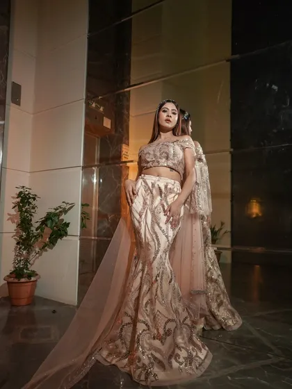 Ethereal elegance for an evening event. This look features a soft smokey eye, shimmering neutral tones, and a subtle nude lip to complement her sequined gown.