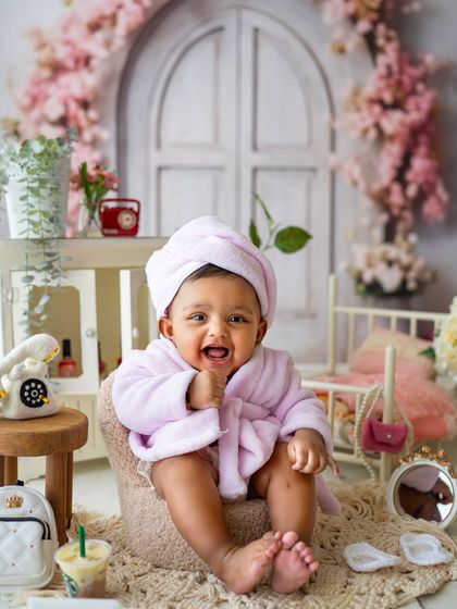 A baby spa day! This little girl is enjoying her "treatment" in a fluffy robe. This is one of my most requested creative themes for baby girls.