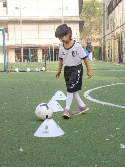 A moment of concentration during a simple cone exercise. We believe in giving every child the help and hope they need to believe in their own abilities.