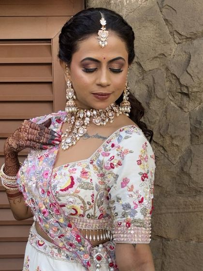 A closer look at this bride's stunning makeup. The focus was on her eyes, with a warm brown smokey look, and a flawless base that looked perfect against the stone wall backdrop.