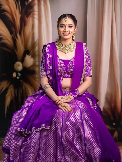 The full bridal look, showcasing the vibrant purple outfit and the elegant, traditional styling.