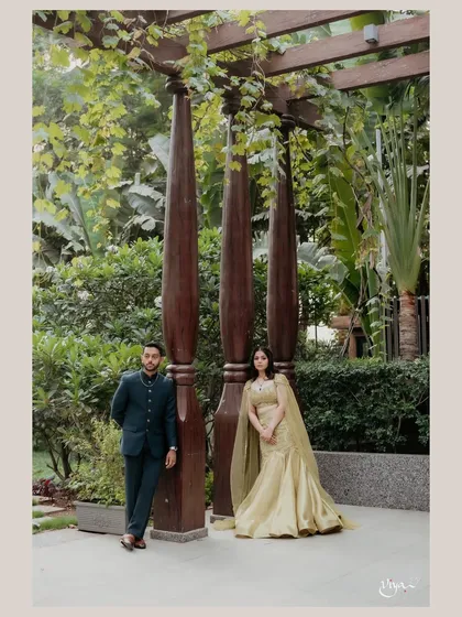 A stylish pose by the couple. The bride's soft glam makeup and flowing gown create a romantic and modern feel.