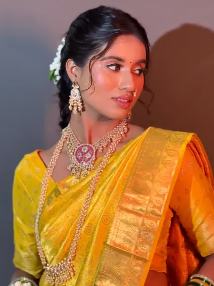 Your Haldi look should be fresh, vibrant, and joyful. For this client, I created a luminous look with a pop of color on the eyes that complemented her beautiful yellow saree, ensuring she looked radiant for this special pre-wedding ceremony.