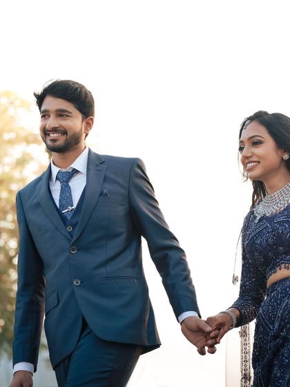 A candid walking shot of the couple, filled with happiness and laughter. Dr. Akshara's modern reception look is perfect for these dynamic photos.