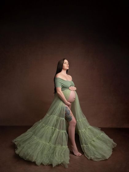 This tiered olive green tulle gown offers a softer, more romantic alternative to the satin version. The open front beautifully showcases the baby bump.