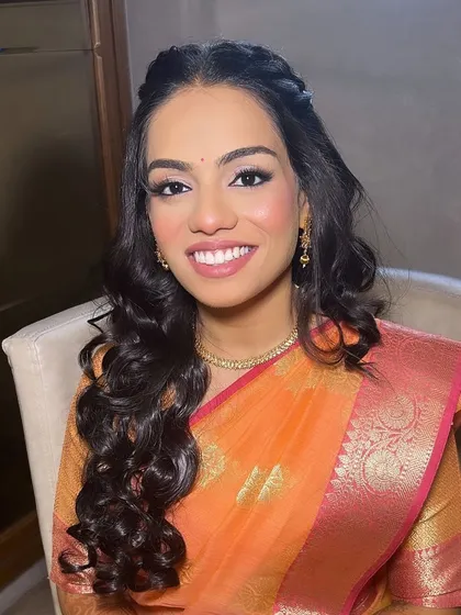 A beautiful smile from the engagement bride. The makeup is natural and radiant, enhancing her happiness.