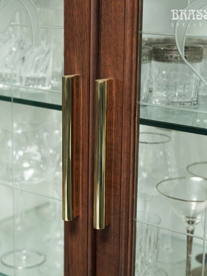 A detail shot of the Kiah pulls, showing their clean profile and the beautiful reflection from the polished brass.
