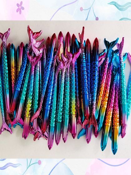 A large batch of the iridescent mermaid tail pens. Their unique design and shimmering colors make them a very popular choice for party favors.