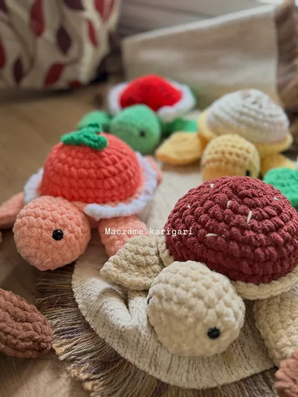 A little family of our fruit-inspired chunky yarn turtles. We offer a variety of designs, from strawberry to lemon, each one handmade and full of character.