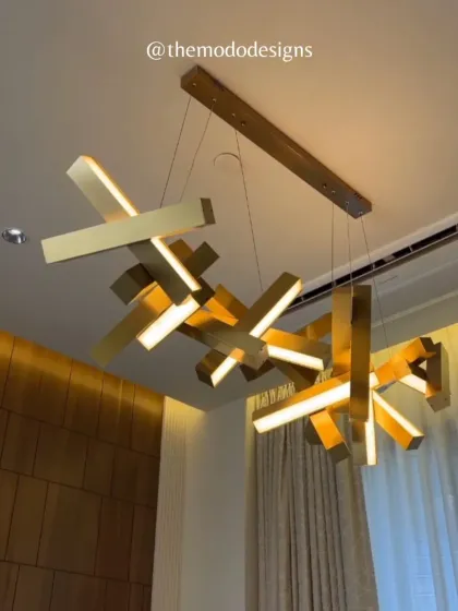 Lighting is the jewelry of a room. This contemporary chandelier acts as a functional sculpture, adding a bold, artistic statement to the space while casting a warm and inviting glow. It exemplifies our belief in using unique pieces to give every project a distinct personality.
